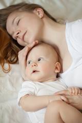 Mom and baby. Mother with daughter or son. Tenderness and embrace, happiness maternity, home comfort and warmth.