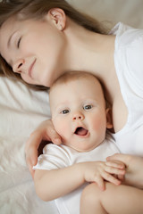 Mom and baby. Mother with daughter or son. Tenderness and embrace, happiness maternity, home comfort and warmth.