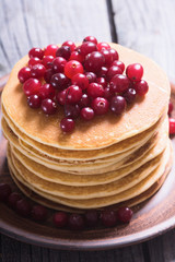 A stack of pancakes with cranberries