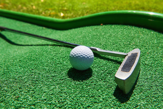 Golf ball and Golf Club on Artificial Grass
