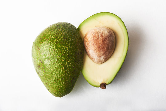 2 parts avocado isolated on white background.