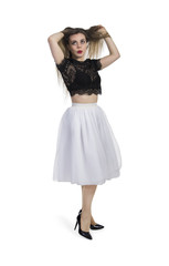 Emotional girl in white skirt posing on a white background.