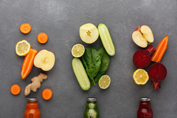 Detox smoothies with ingredients in glass bottles on gray background.