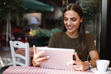 Young woman using a digital tablet in a cafe