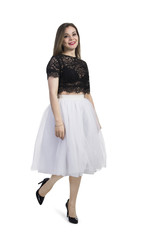 Fototapeta premium Emotional girl in white skirt posing on a white background.