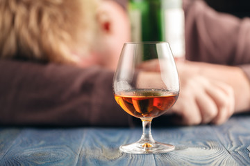 Man abusing alcohol for relaxing, whisky in glass