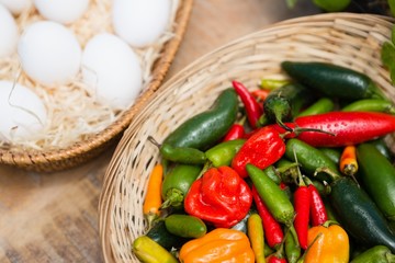 Fresh vegetables and eggs in wicker basket