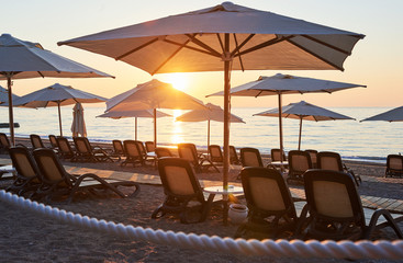 Scenic view of sandy beach on the beach with sun beds and umbrellas open against the sea and mountains. Hotel. Resort. Tekirova-Kemer