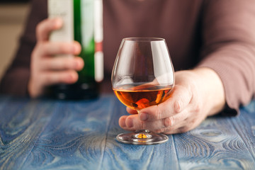 Man pouring whiskey himself in glass