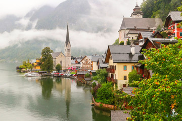 Scenic view of famous Hallstatt mountain village in the Austrian Alps with misty raining, Salzkammergut region, Austria