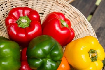 Fresh bell peppers in wicker basket