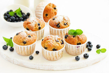 Oat muffins with blueberries on a dark background.