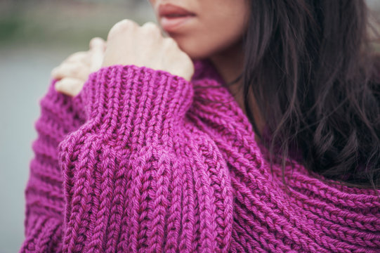 Violet knit cardigan on the girl with long hair, details.