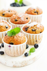 Oat muffins with blueberries on a dark background.