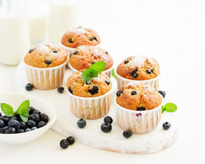 Oat muffins with blueberries on a dark background.