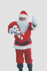 Real Santa Claus carrying big bag full of gifts, isolated on white background