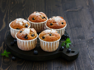 Oat muffins with blueberries on a dark background.