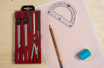 School metal compasses stationary set for drawing, pencil, protractor, graph paper and sharpener on...