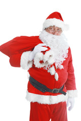 Real Santa Claus carrying big bag full of gifts, isolated on white background