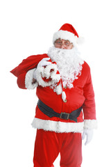 Real Santa Claus carrying big bag full of gifts, isolated on white background