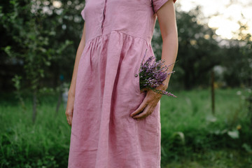 The girl in a delicate pink dress with flowers