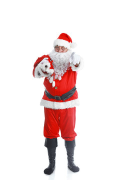 Real Santa Claus carrying big bag full of gifts, isolated on white background