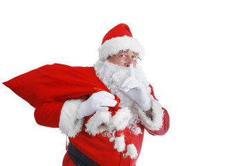 Real Santa Claus carrying big bag full of gifts, isolated on white background