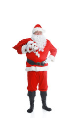 Real Santa Claus carrying big bag full of gifts, isolated on white background