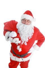 Real Santa Claus carrying big bag full of gifts, isolated on white background