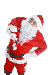 Real Santa Claus carrying big bag full of gifts, isolated on white background