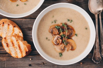 Cream soup puree with mushroom on wooden background