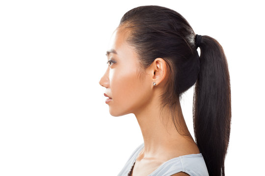 Closeup portrait of Asian young woman in profile with ponytail