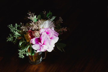Floral dcoration in a glass vase with dark background