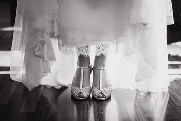 Bride with dress and shoes ready for the wedding black and white