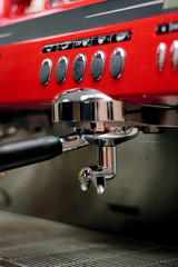 Red metal coffee machine at cafe or restaurant.