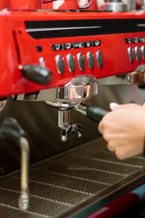 Red metal coffee machine at cafe or restaurant.