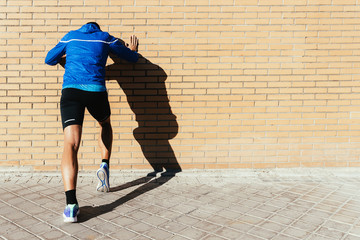 Handsome man stretching in the city. © santypan
