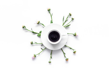 Floral pattern. Cup of coffee and buds and leaves on white background top view copyspace