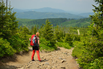 Hikings along tourist trails in the mountains Beskid in Poland with the backpack on the back