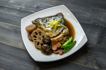 Steamed salmon head with soy sauce with vegetables., Salmon kabutoni, Close up Salmon