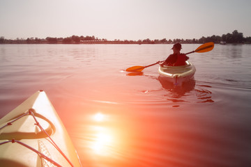 Boy in life jacket on green kayak