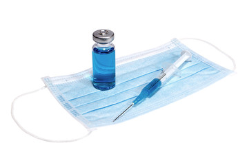 Syringe  and phial with blue vaccine on the medical face mask
