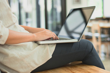 college woman sitting and working on a laptop