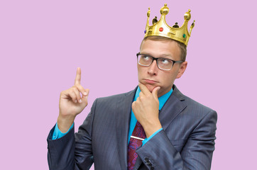 Expert opinion. Judge. Young caucasian business man in suit and glasses and with golden crown above...