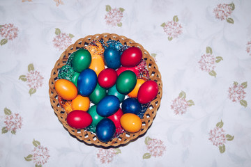 Fototapeta premium Colorful easter eggs in basket. Happy Easter, Christian religious holiday.