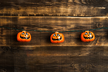 Halloween pumpkin heads on wooden background