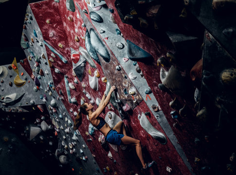 Female climber. Extreme indoor climbing.