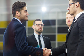 Successful business partners handshaking after negotiation or by meeting