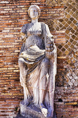 Ancient Roman Statue of Goddess Fortuna Annonaria in the courtyard of the Domus of Fortune Annonaria in Rome - obrazy, fototapety, plakaty