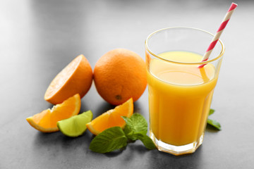 Glass of fresh orange juice on table